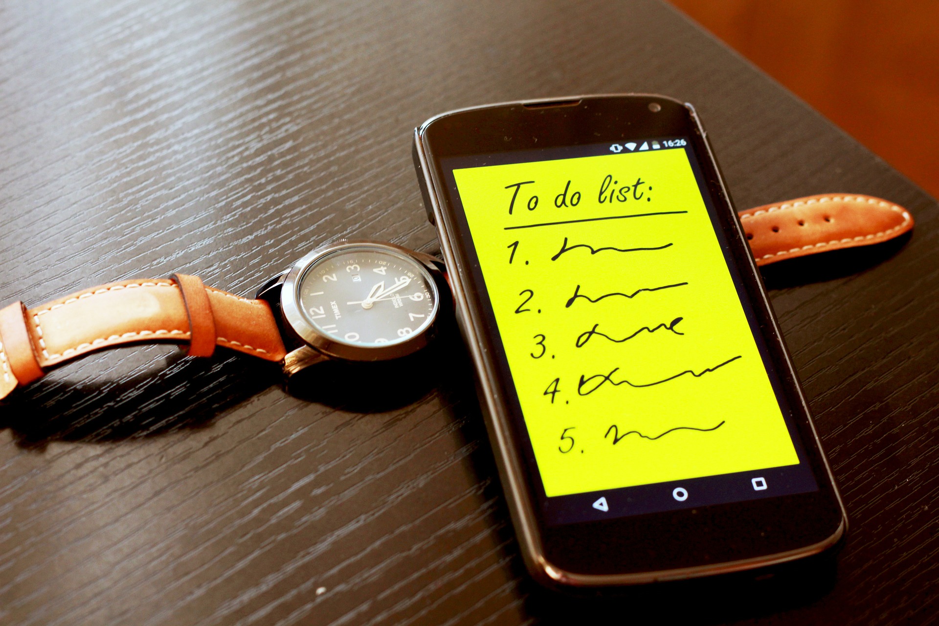 To do list on a phone with a watch.